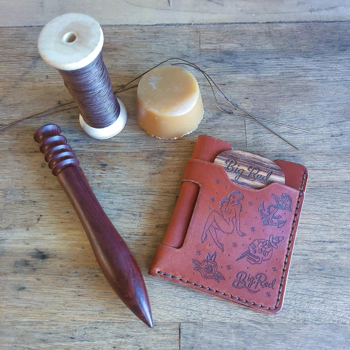 Big Red Tattoo Minimalist leather wallet with No. 5 wooden beard comb and leatherworking tools