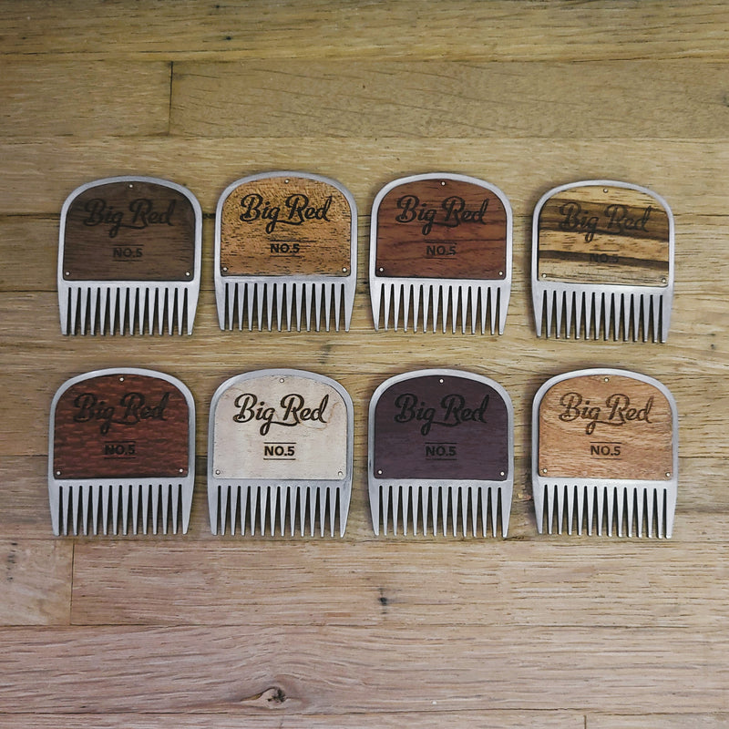 No. 5 stainless steel beard comb collection with assorted natural wood handles on a work bench